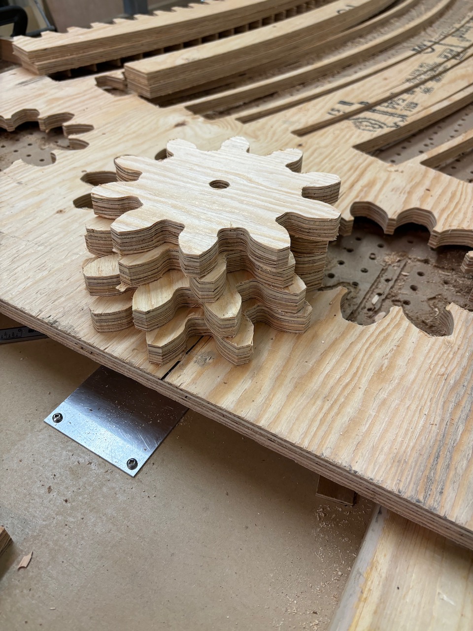 The Pinion Gear was assembled from two layers of three quarter inch plywood then attached to a 1 HP DC motor plus controls for two direction, variable speed rotation.